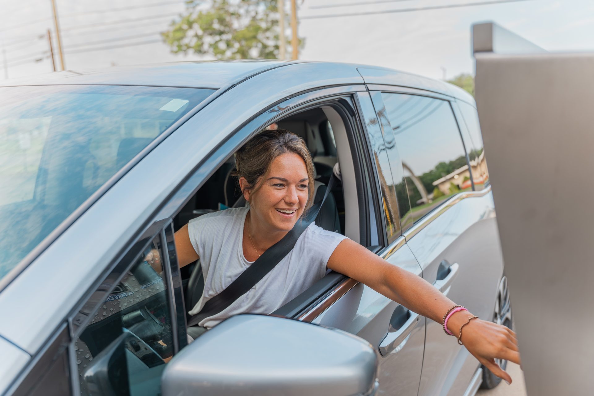 Smiling driver at the Otter Car Wash pay kiosk